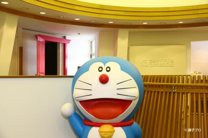 高岡市藤子・F・不二雄ふるさとギャラリー内の施設にて、出迎えるように立っている、「ドラえもん」の等身大人形を写した写真