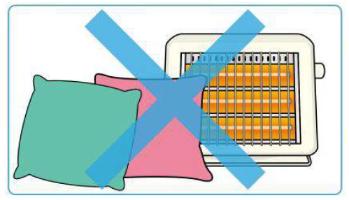 ストーブの近くにクッションを二つ置いたイラスト